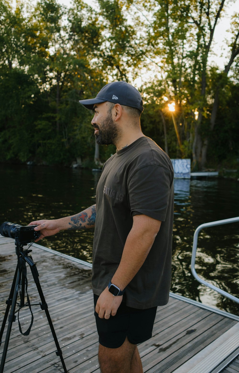 a man standing on a dock with a camera
