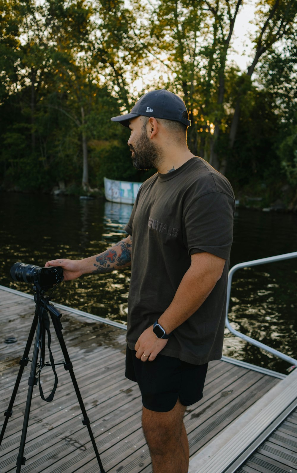 a man standing on a dock with a camera