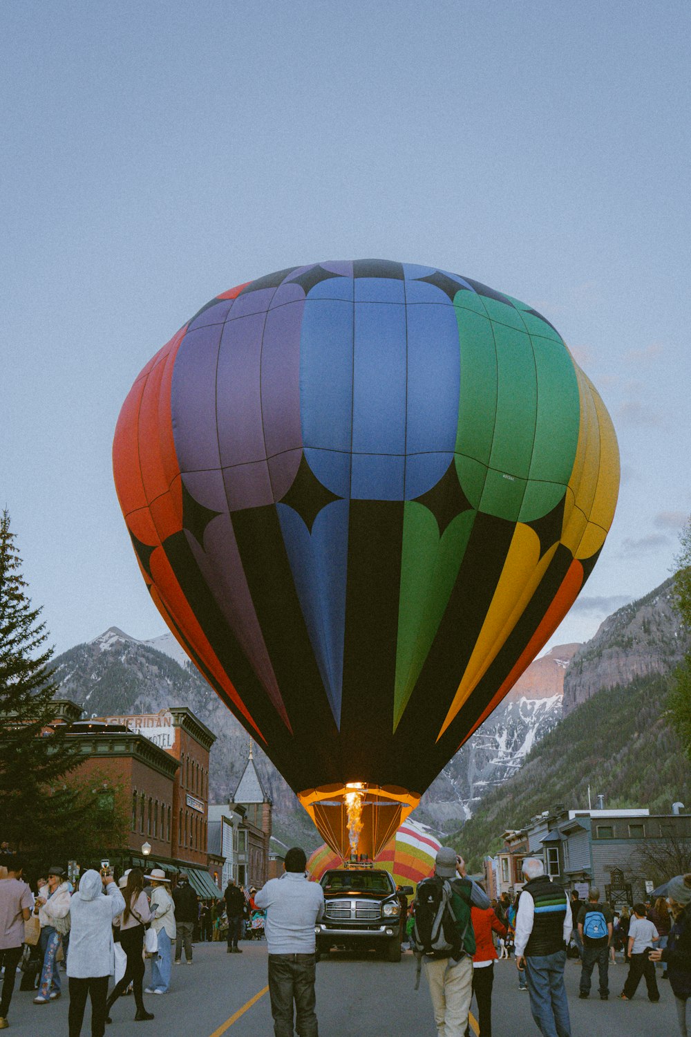 a group of people standing around a hot air balloon