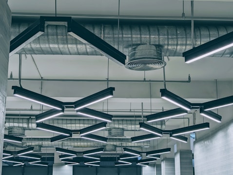 Close-up of a sleek modern ceiling with precise copper accent lighting highlighting texture.