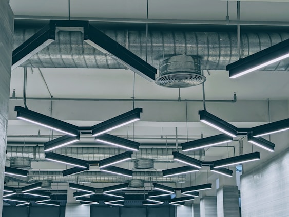 Close-up of a modern ceiling installation showcasing smooth textures and copper accent lighting.