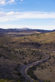 A winding road in the middle of a hilly area