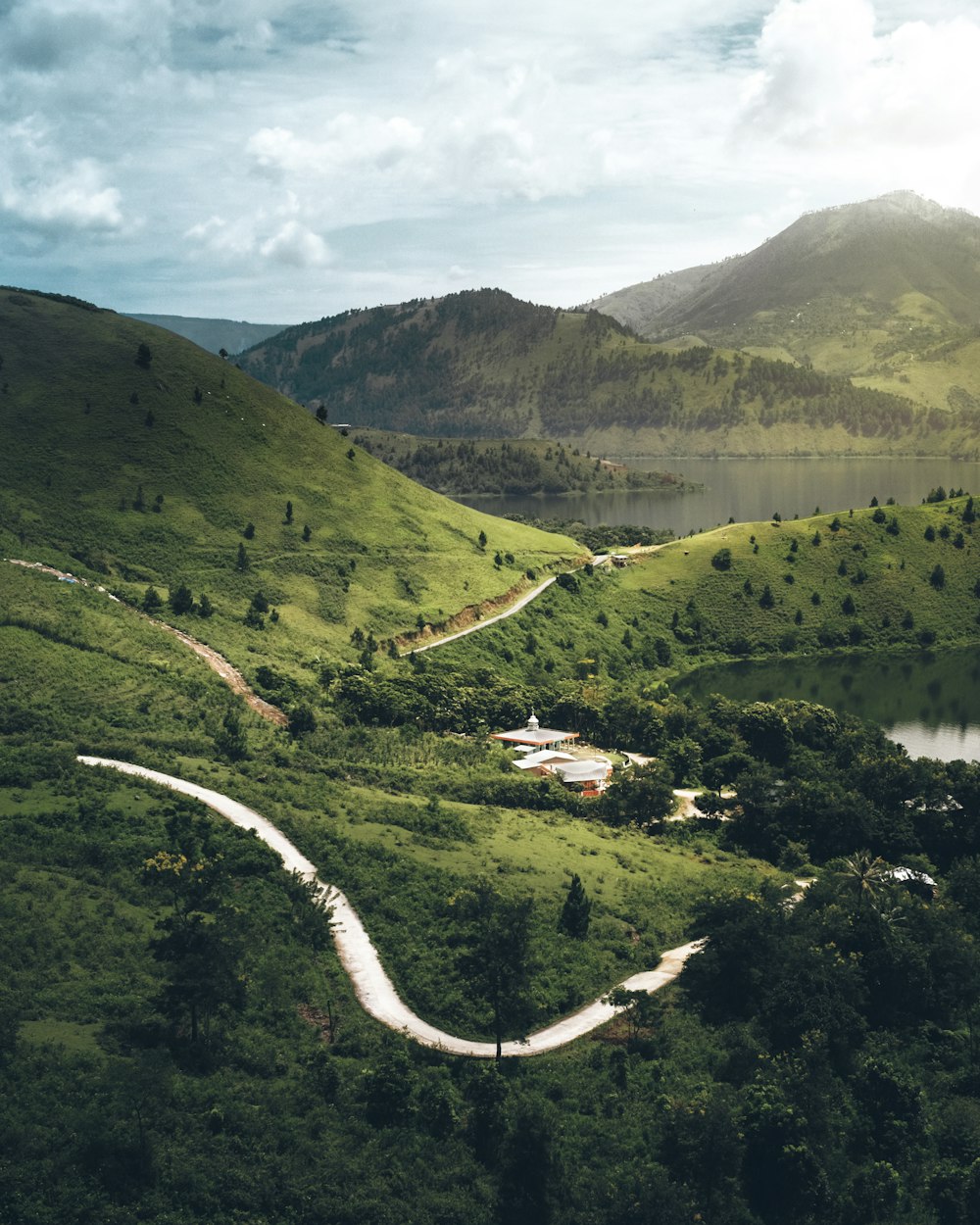 a scenic view of a winding road in the mountains