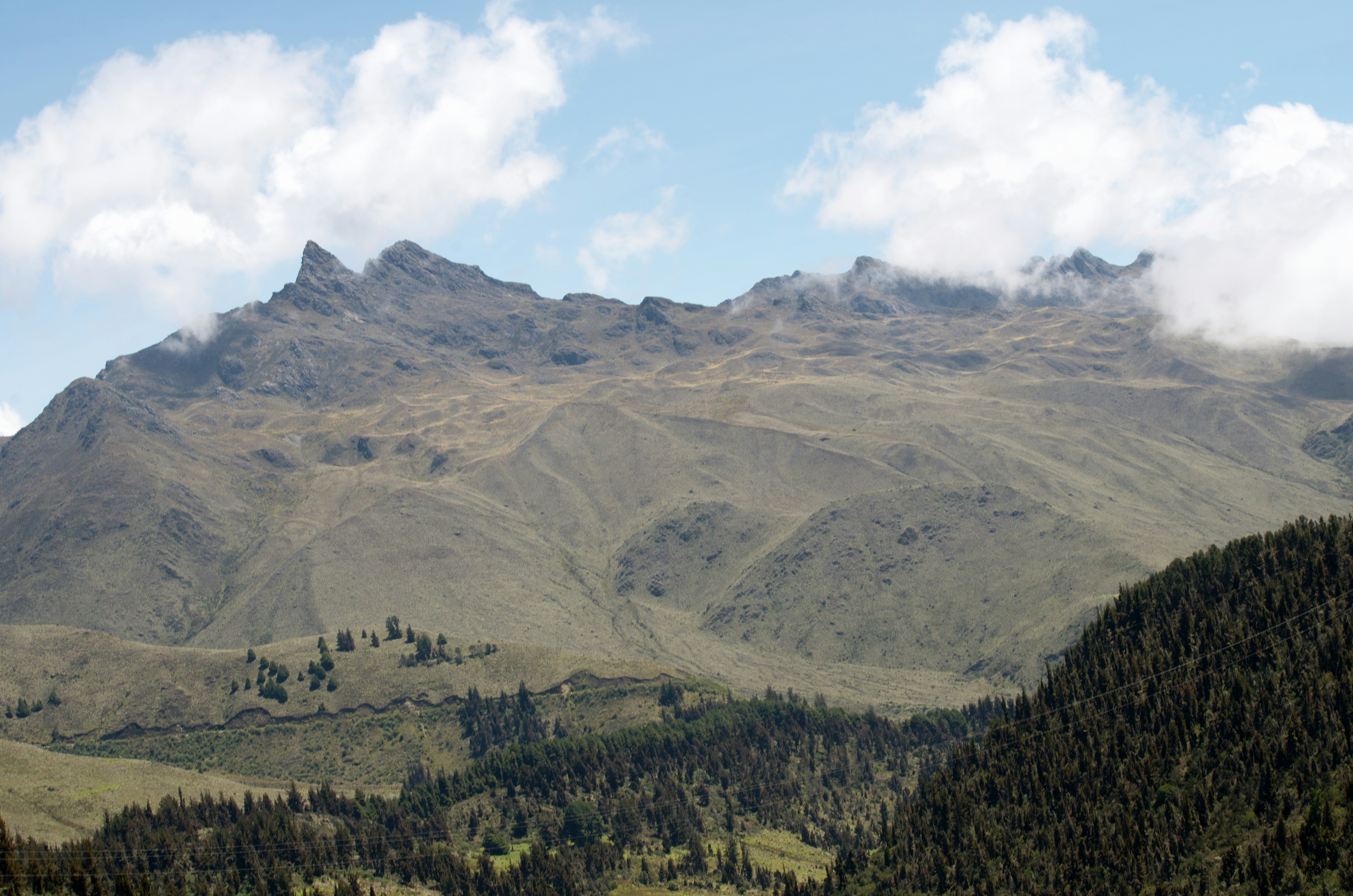 a view of a mountain range with clouds in the sky