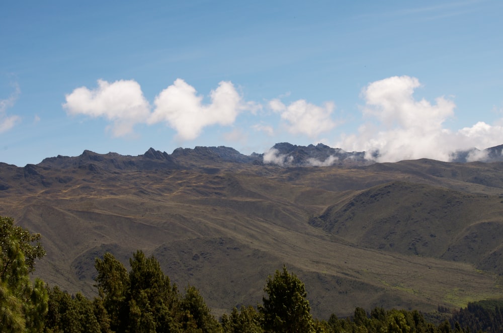 a view of a mountain range with clouds in the sky