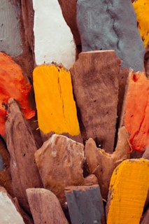 Several wood panels arranged artistically showcasing different colors and painted patterns