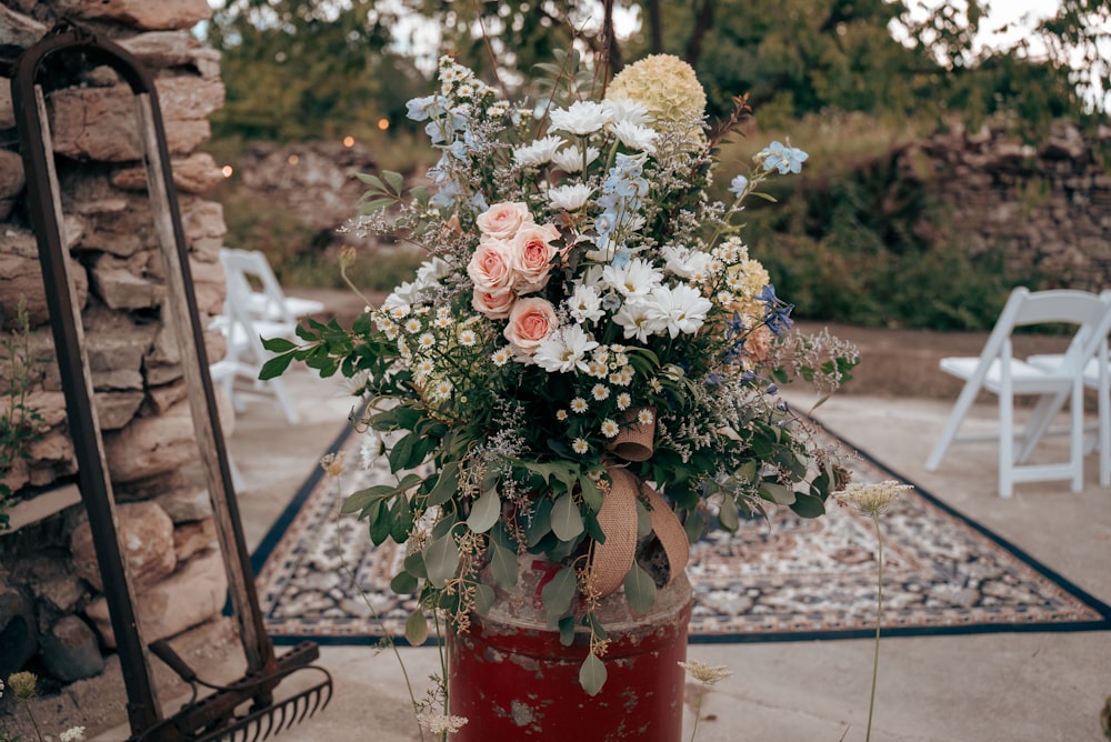 a vase filled with lots of flowers on top of a table