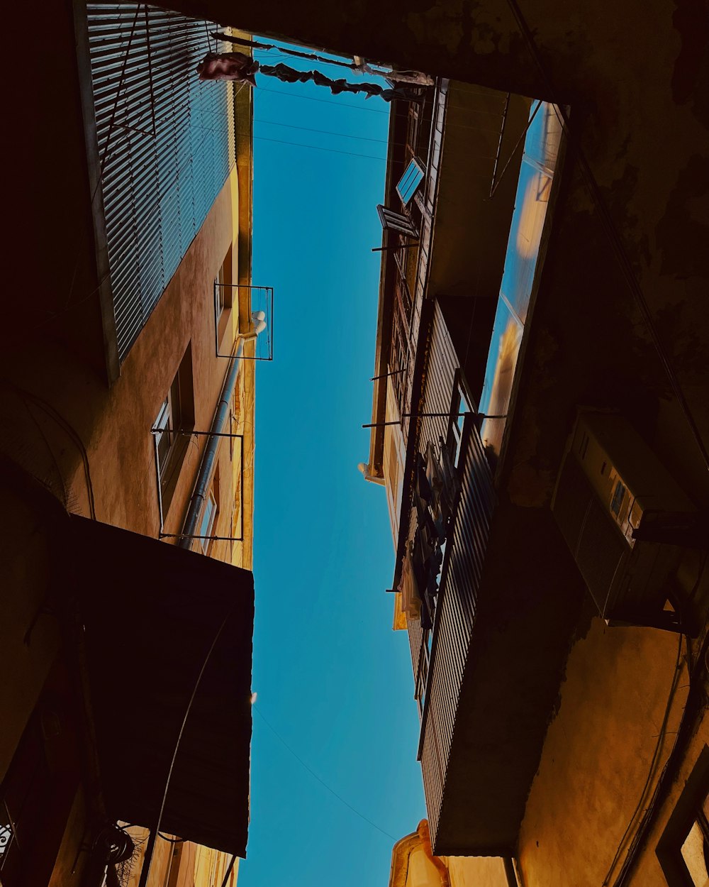 looking up at the sky from a narrow alleyway