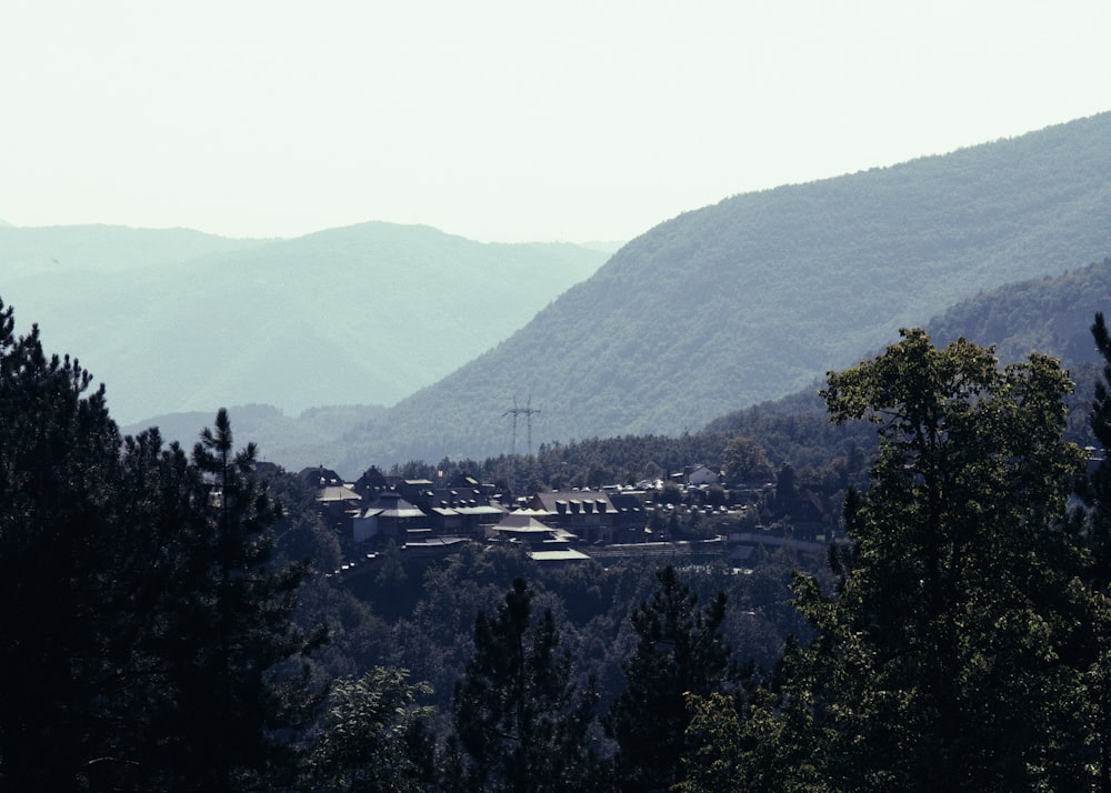 a scenic view of a town nestled in the mountains