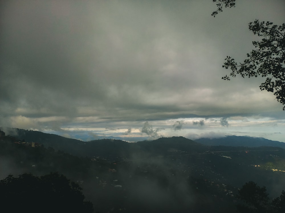 a view of a mountain range with clouds in the sky