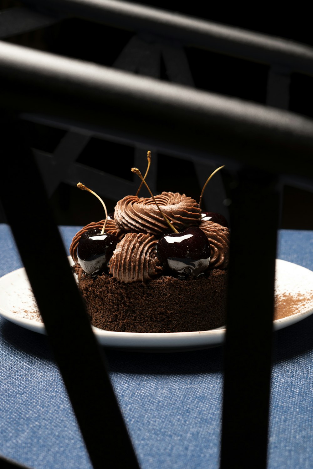 a piece of chocolate cake sitting on top of a white plate