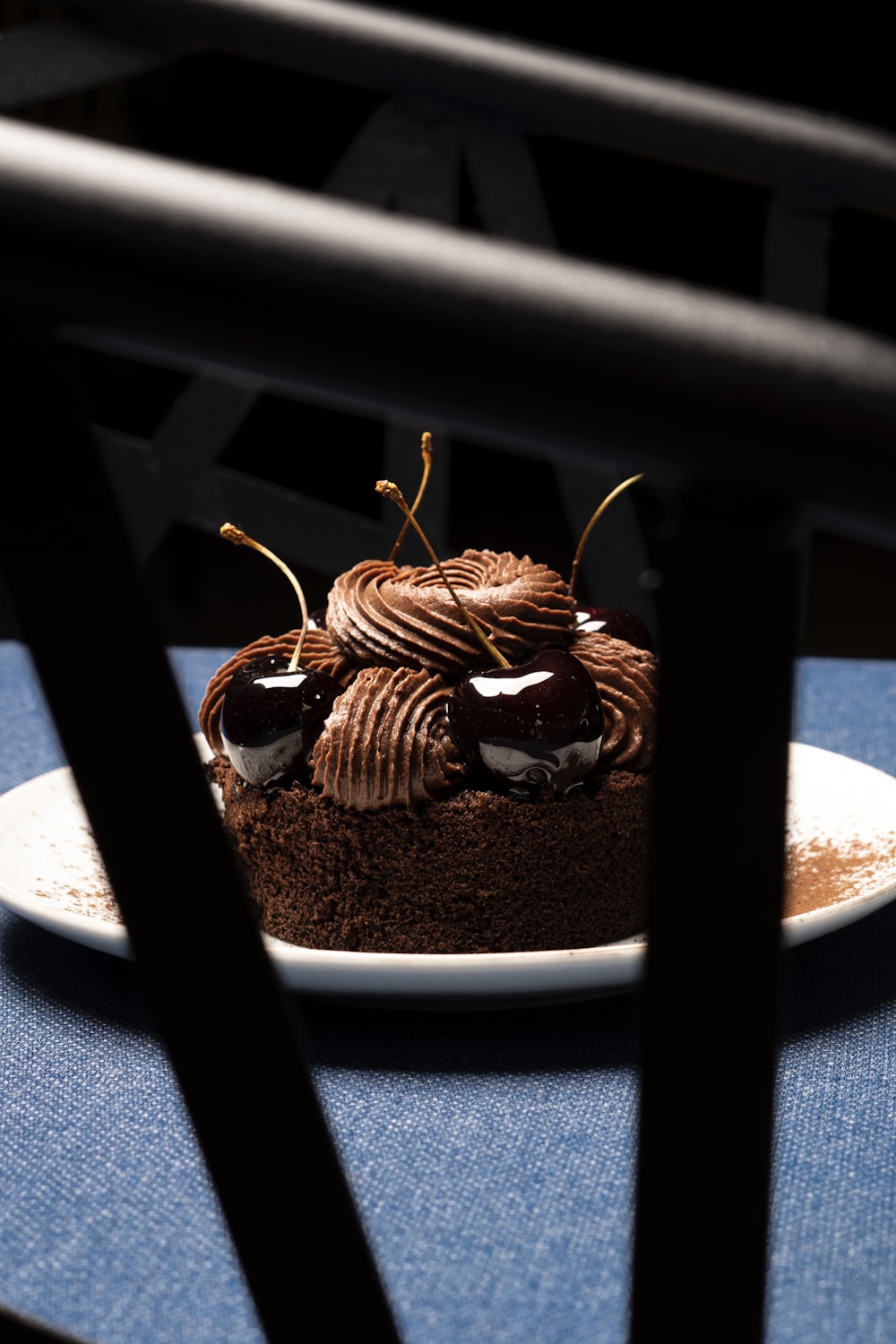 a piece of chocolate cake sitting on top of a white plate