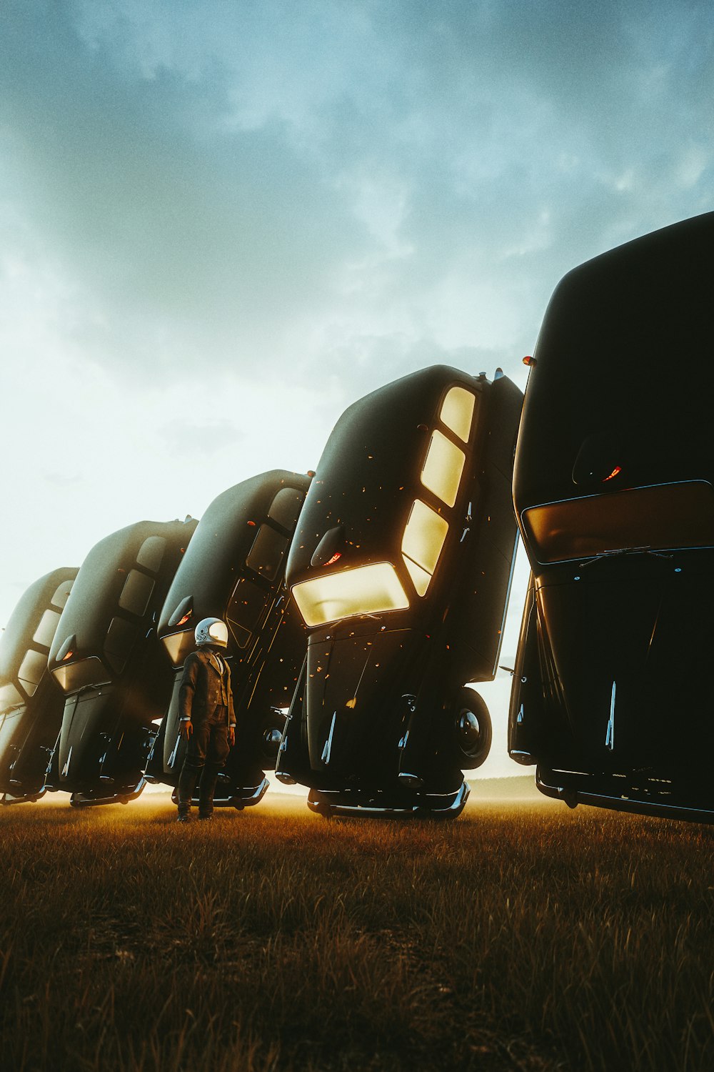 a group of futuristic vehicles sitting on top of a grass covered field