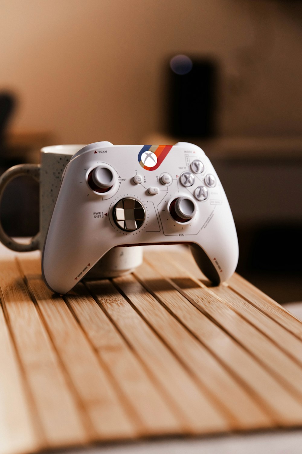 a game controller sitting on top of a wooden table