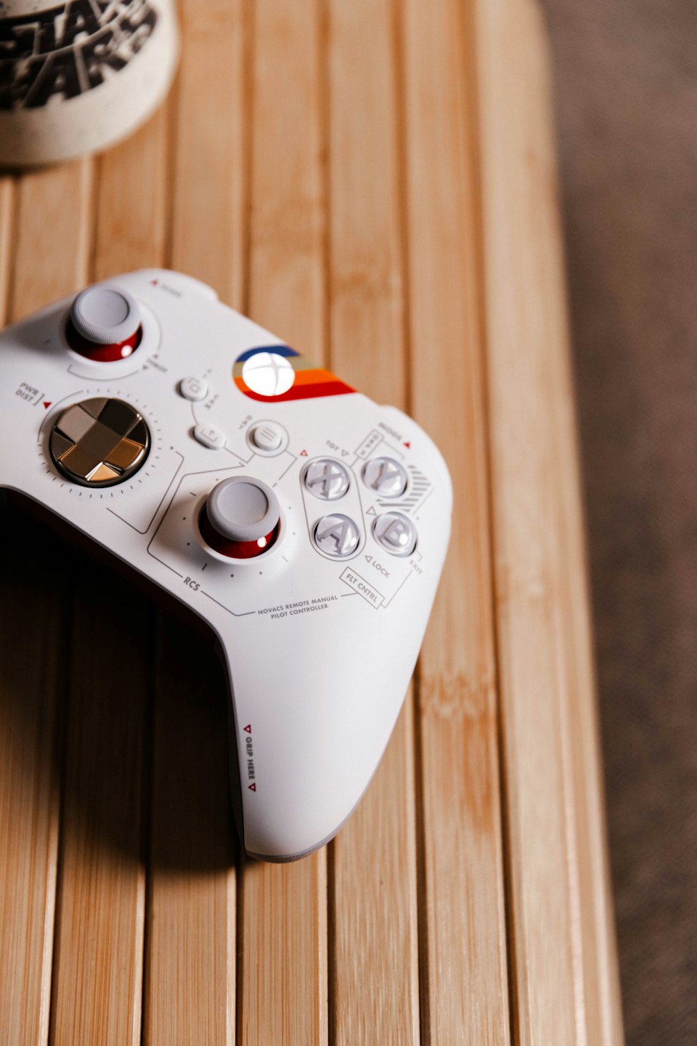 a white controller sitting on top of a wooden table