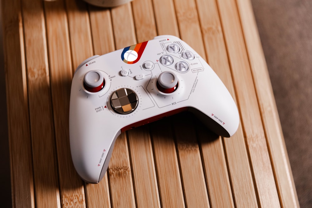 a white controller sitting on top of a wooden table