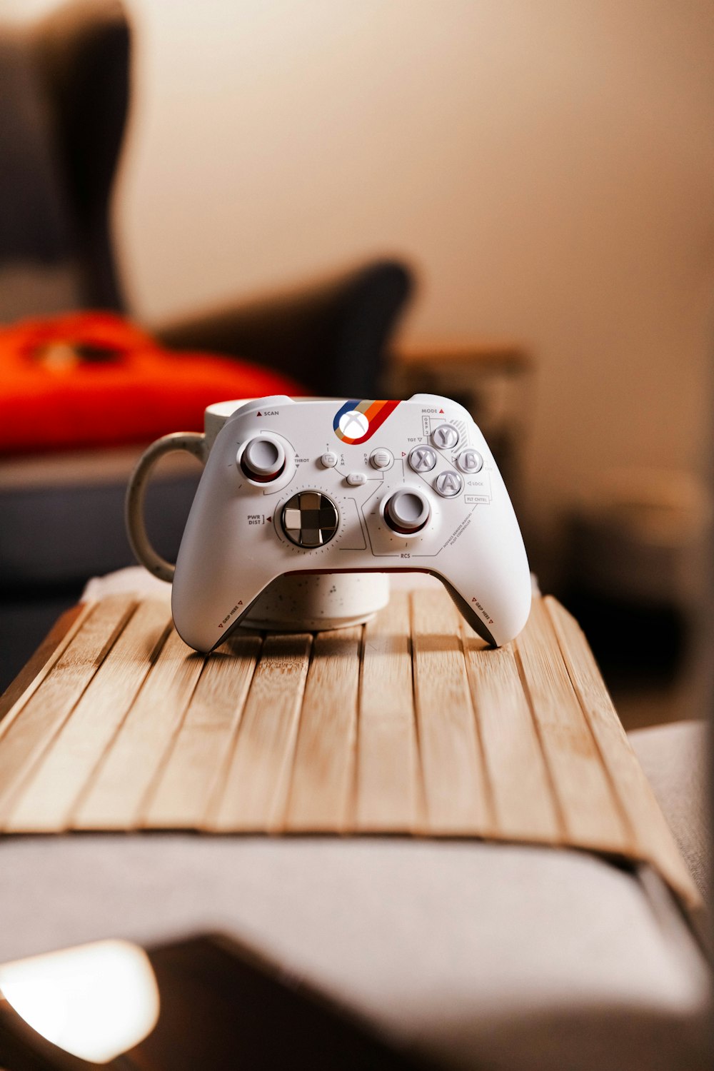 a video game controller sitting on top of a wooden table