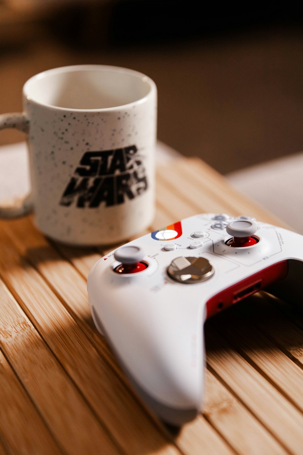 a game controller and a coffee mug on a table