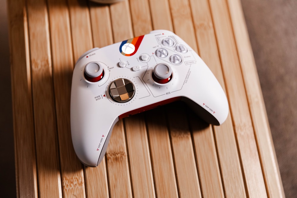 a white controller sitting on top of a wooden table