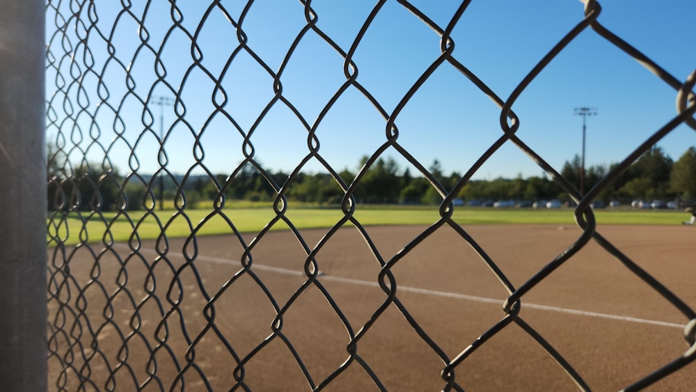 a baseball field behind a chain link fence