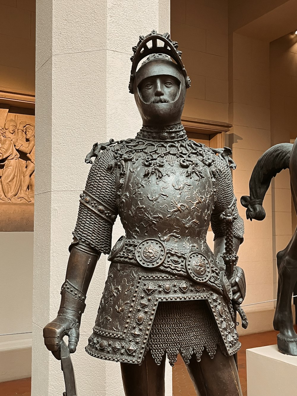 a statue of a man in armor with a horse