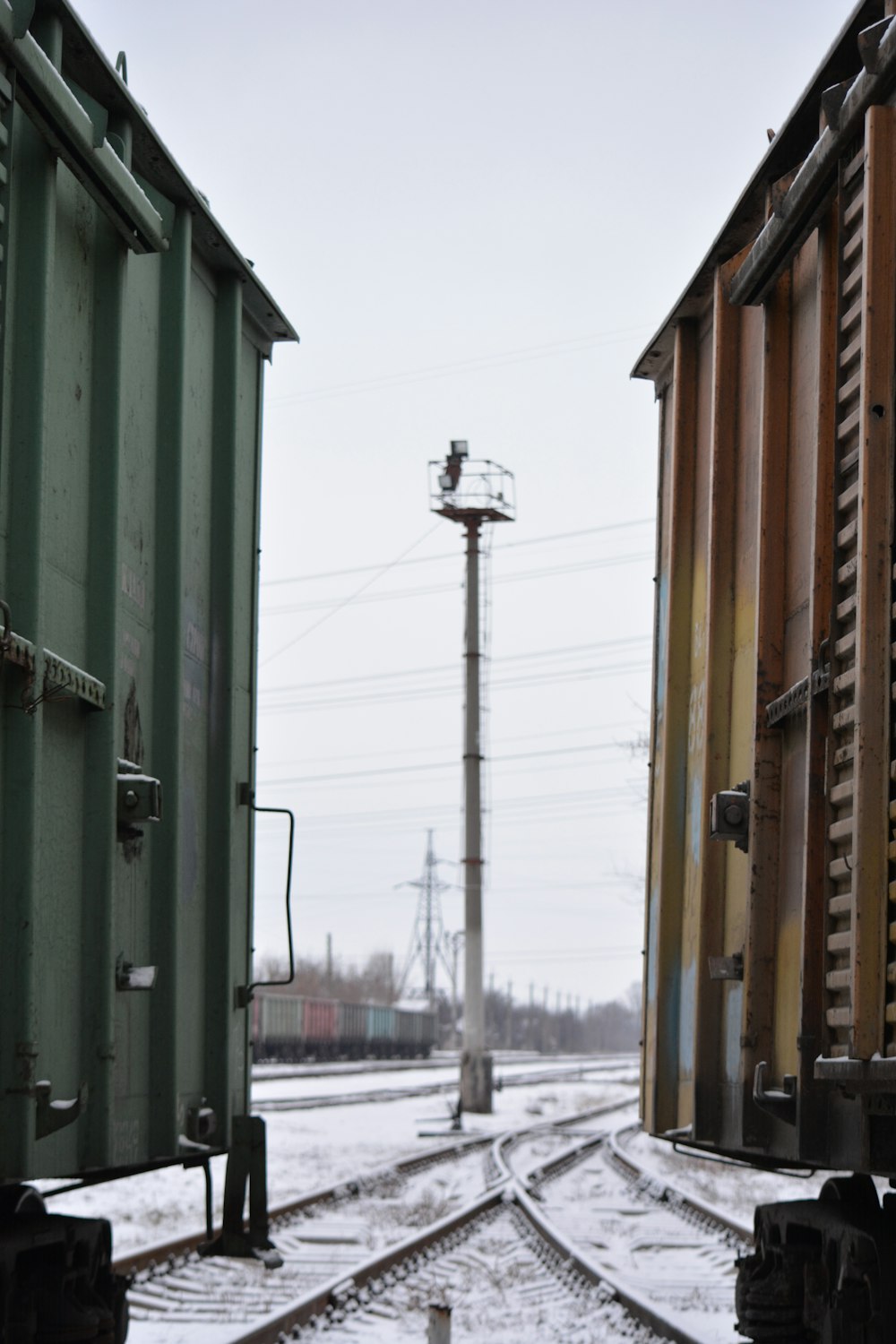 a couple of train cars sitting on top of train tracks