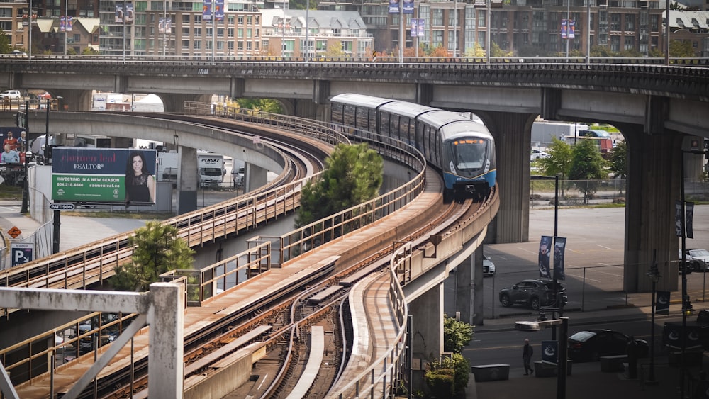 a train traveling down tracks under a bridge