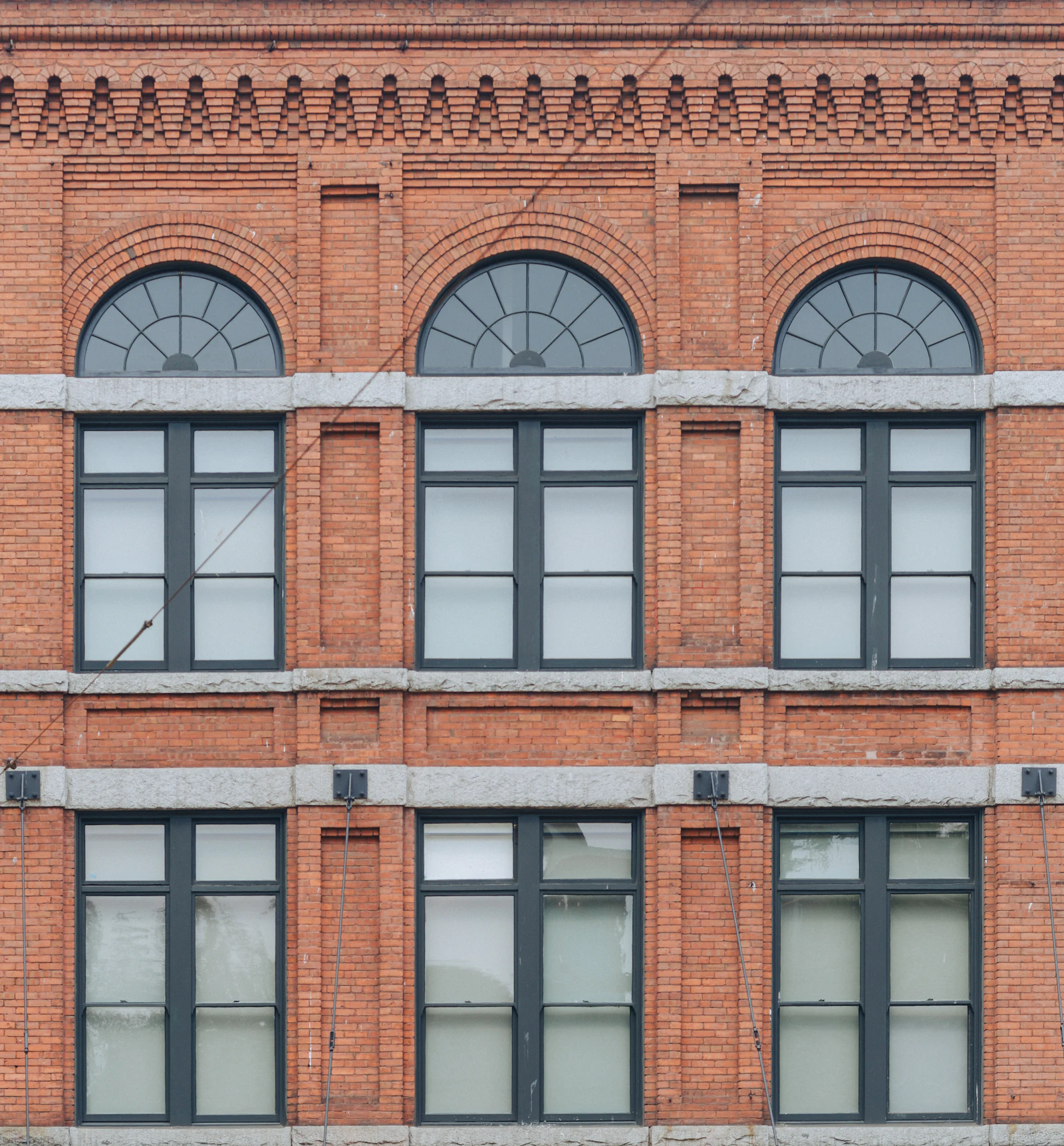 Brick building facade with arched windows