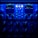 A close-up view of an audio processing panel, featuring various knobs, dials, and buttons. The panel displays intricate details such as compression meters, EQ controls, and frequency adjustments. The lighting casts a deep blue hue over the entire panel, giving it a high-tech, sophisticated appearance.