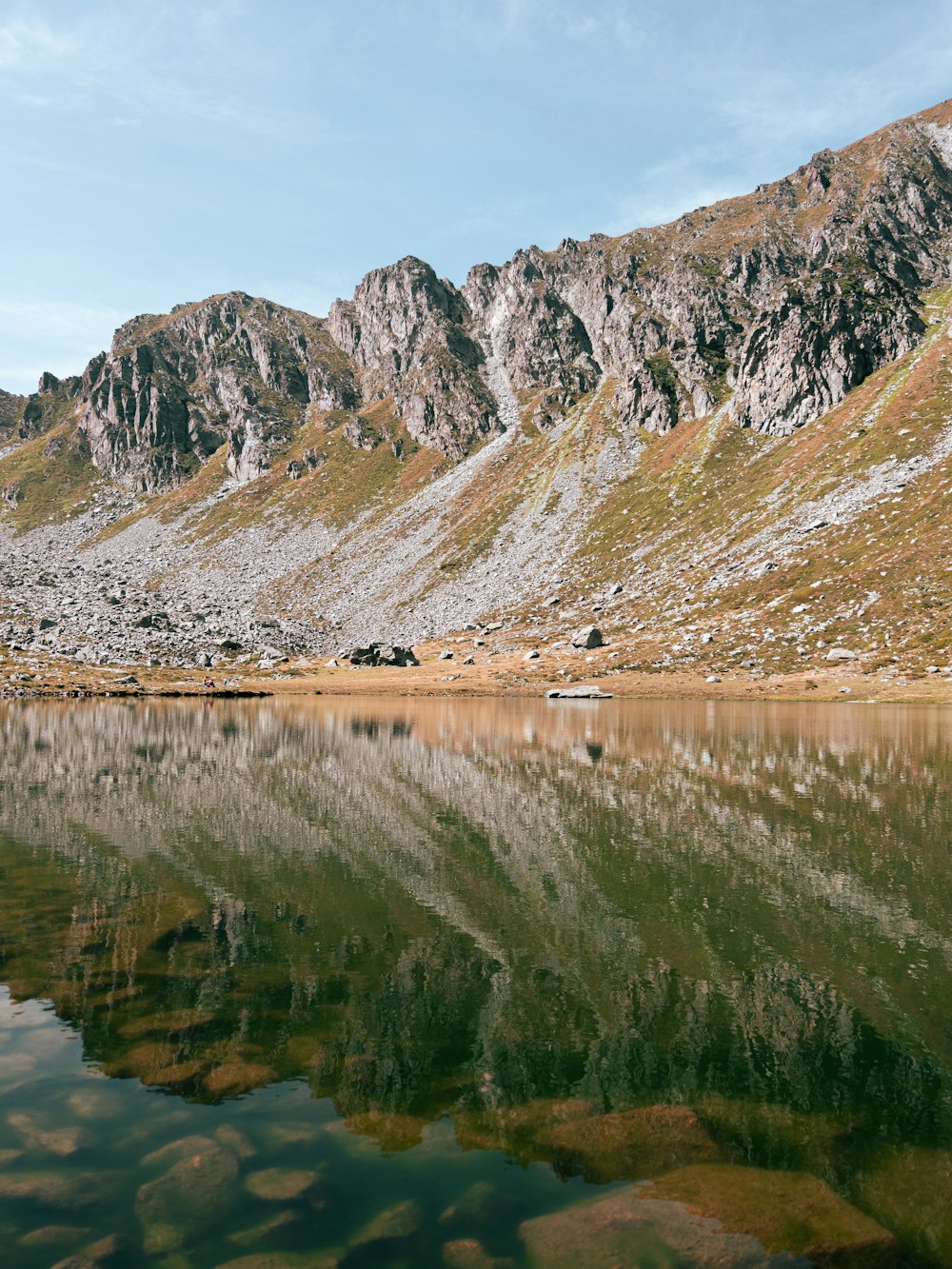 a mountain range with a lake in the foreground