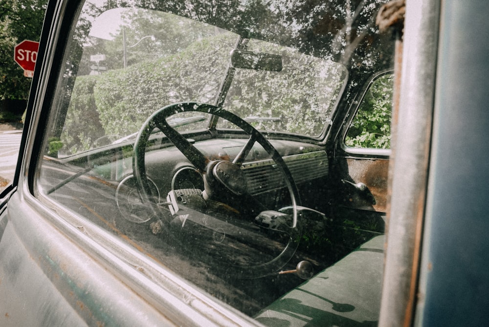 an old truck with a steering wheel and dashboard