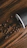 Close-up of a twistara tumbler resting on a wooden table with coffee nearby