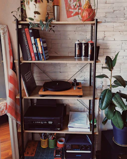 A stylish shelf showcasing a mix of electronic gadgets and tasteful home decor accents.