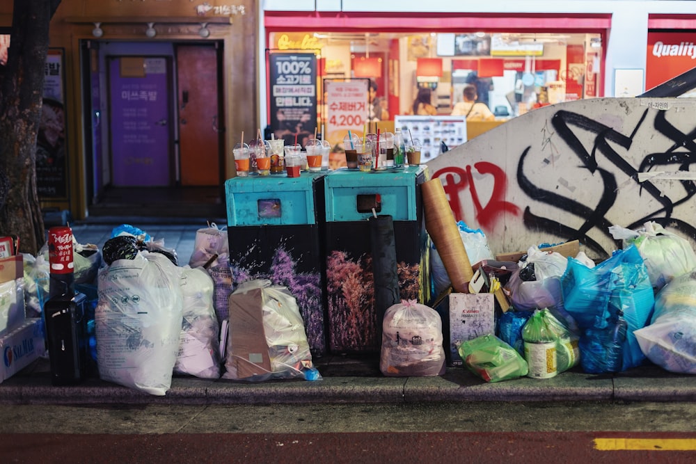 a bunch of bags sitting on the side of a road