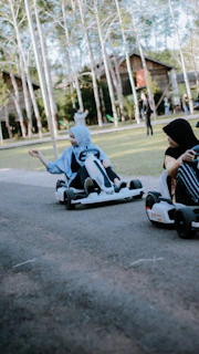 A happy couple sharing a ride in a two-seater gokart, smiling as they race side by side.