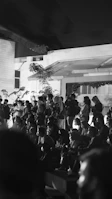 Artistic black and white image of a corporate event with professional attendees.