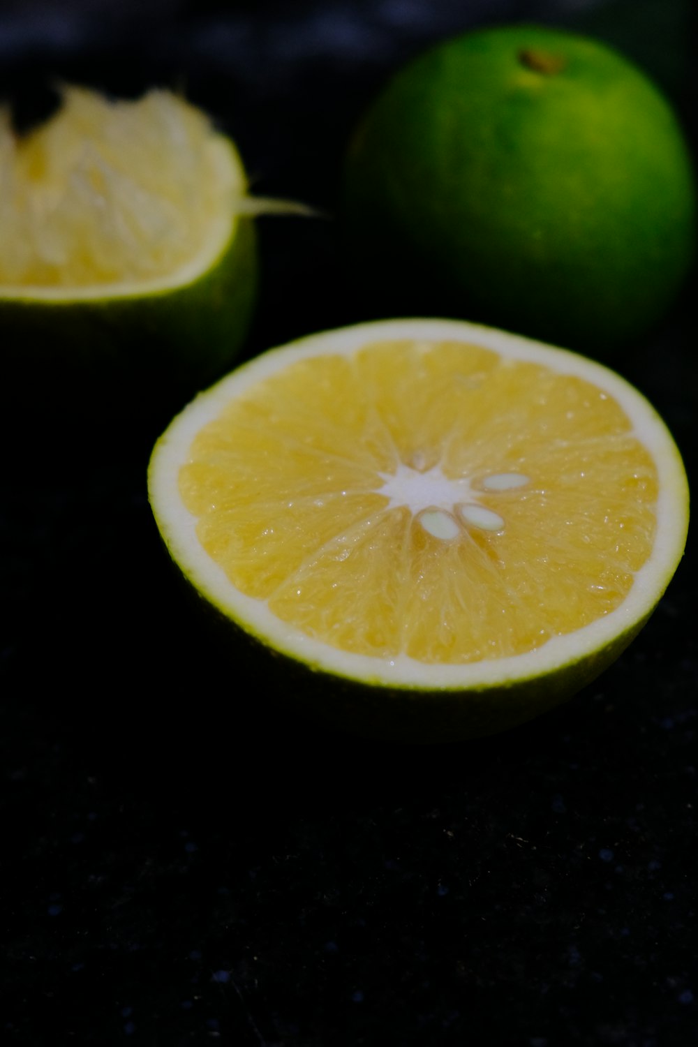 a close up of a lemon and a lime on a table