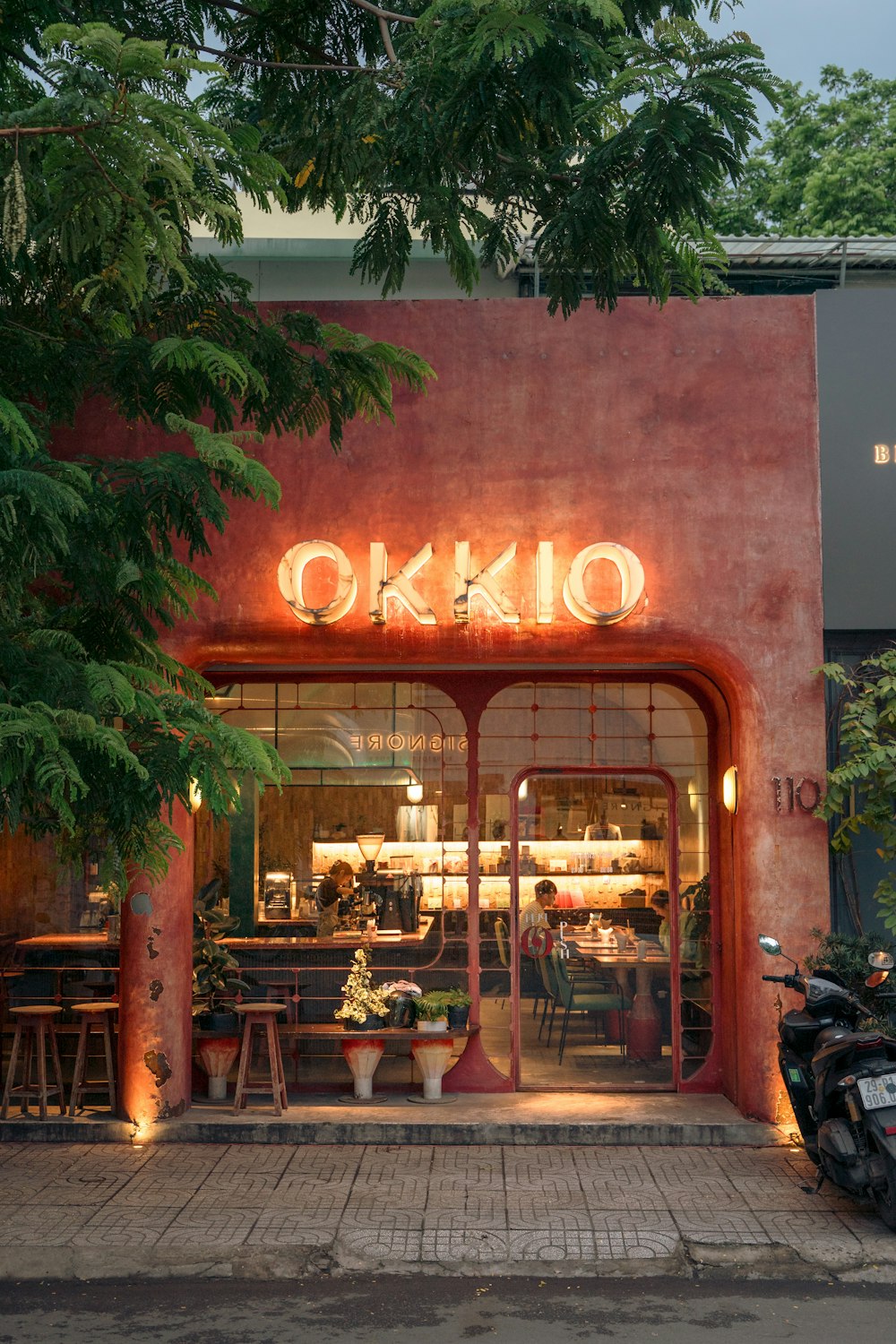 a building with a neon sign that says okko