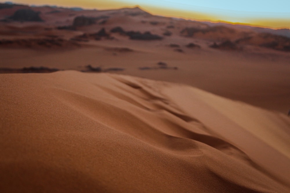 a blurry photo of a desert with sand dunes