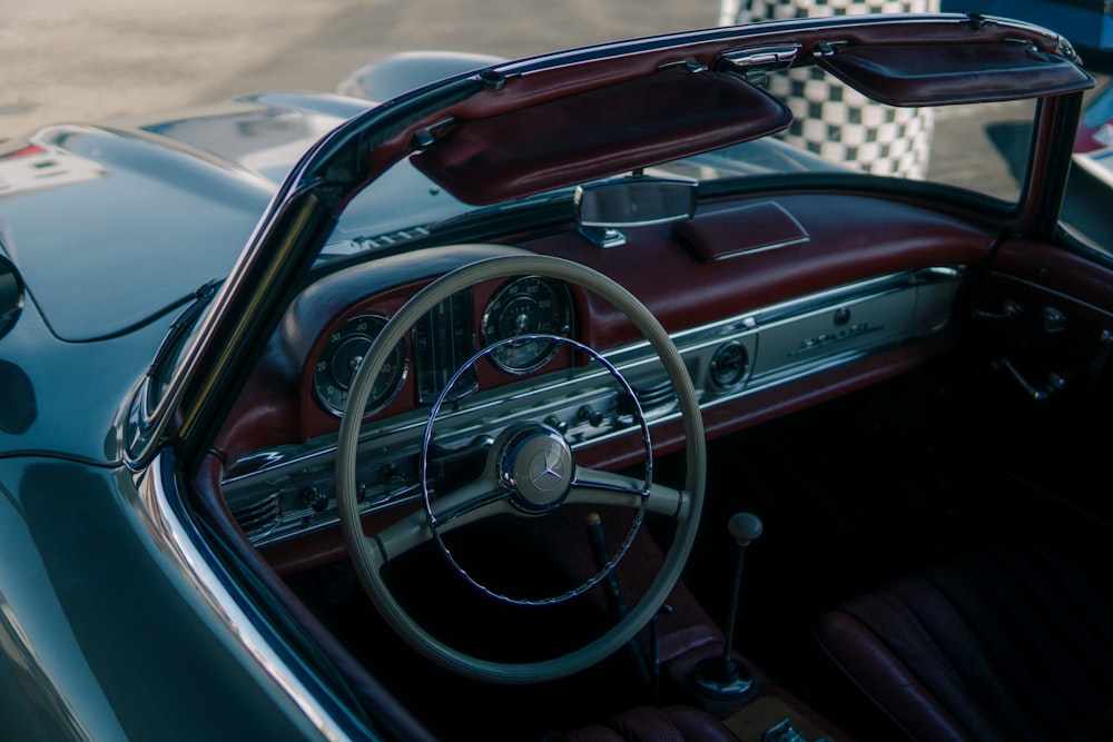 the interior of a classic car with a checkered floor