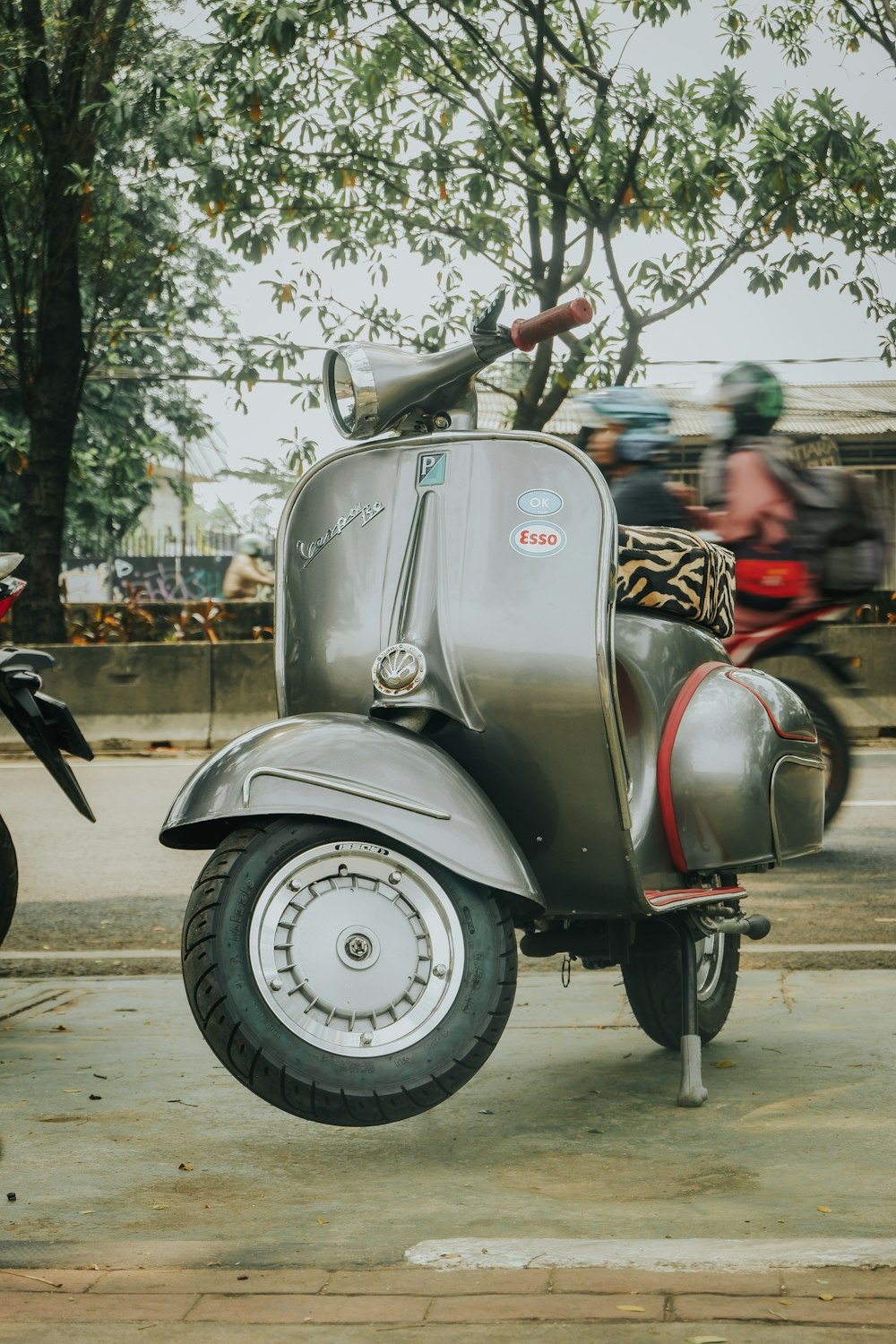 a motor scooter parked on the side of the road