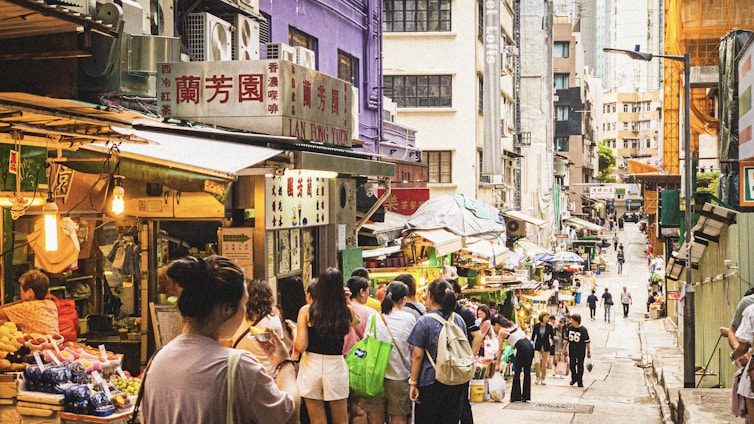 A vibrant street scene in Qingdao with colorful markets and locals enjoying a sunny day.