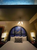A cozy bedroom showcasing ambient lighting fixtures with a unique design.