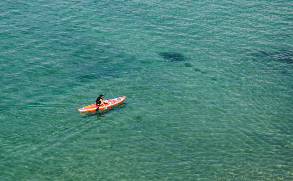 a man riding on top of a surfboard in the ocean