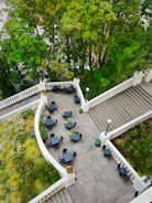 An outdoor patio with elegant seating and greenery.