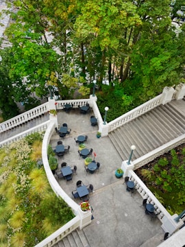 An outdoor patio with elegant seating and greenery.