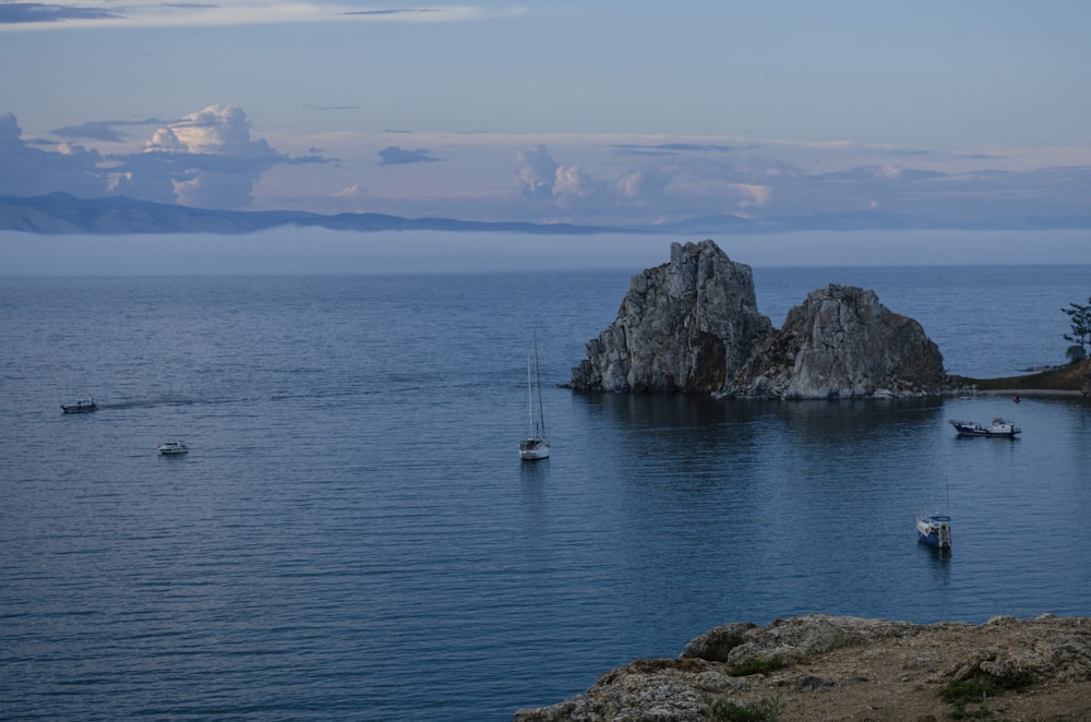 a group of boats floating on top of a large body of water