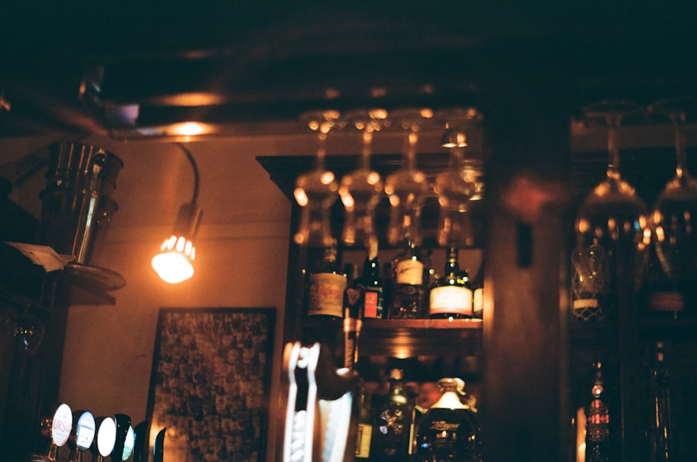 a wine rack filled with lots of bottles and glasses