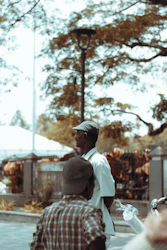 Two men having a thoughtful conversation outdoors in a park.
