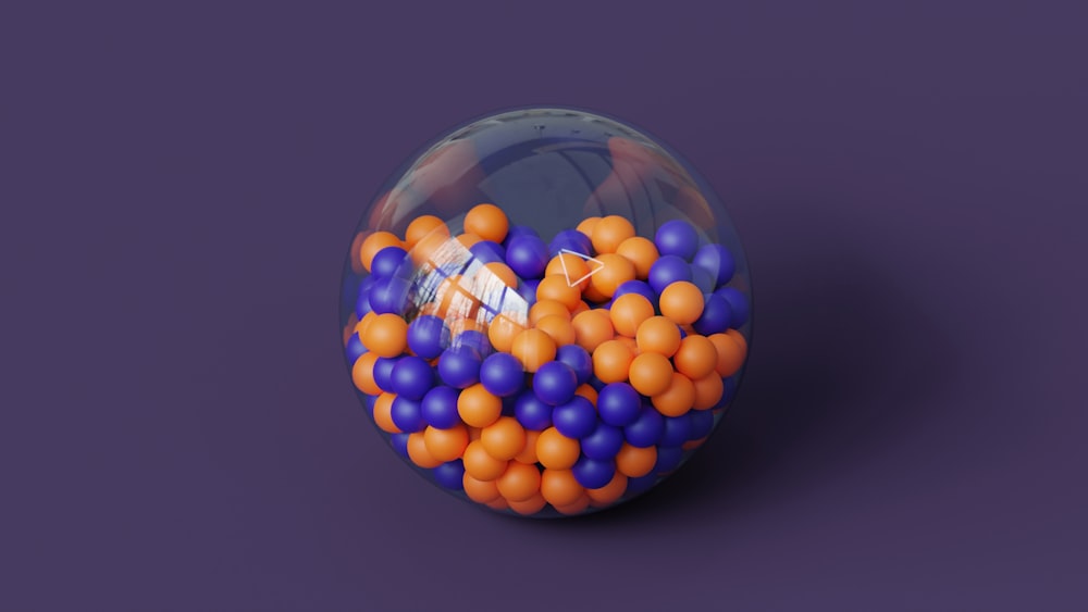a glass ball filled with orange and blue balls